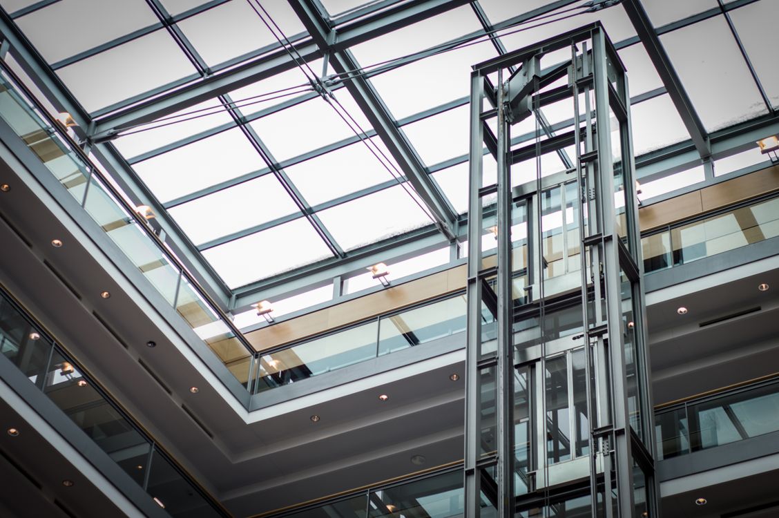 Modern glass elevator in an Abu Dhabi building covered by an AMC contract